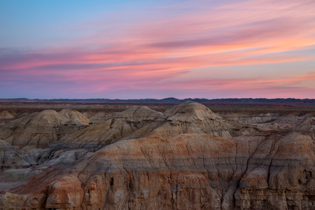 Rainbow Hills in China. Rainbow City, Wucai Cheng. Colorful layered landforms in a remote desert area of Fuyun County. Uygur Autonomous Region, Xinjiang Province. Sunrise - Pink, Purple and Blue Skyのeditorial素材