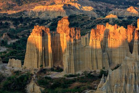 Earth Forest of Yuanmou in Yunnan Province, China - Exotic earth and sandstone formations glowing in...