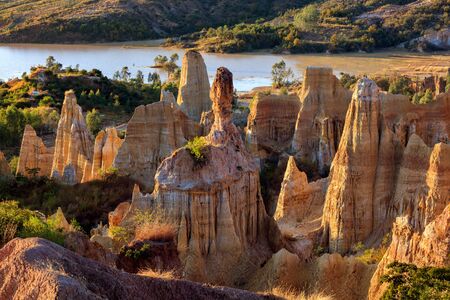 Earth Forest of Yuanmou in Yunnan Province, China - Exotic earth and sandstone formations glowing in the sunlight. Naturally formed pillars of rock and clay with unique erosion patterns. China Travelの写真素材