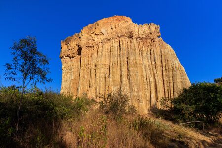 Earth Forest of Yuanmou in Yunnan Province, China - Exotic earth and sandstone formations glowing in the sunlight. Naturally formed pillars of rock and clay with unique erosion patterns. China Travelの写真素材