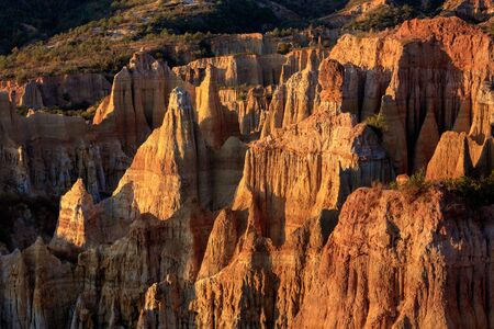 Earth Forest of Yuanmou in Yunnan Province, China - Exotic earth and sandstone formations glowing in the sunlight. Naturally formed pillars of rock and clay with unique erosion patterns. China Travelの写真素材