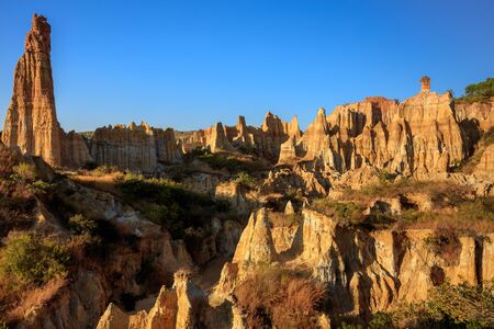 Earth Forest of Yuanmou in Yunnan Province, China - Exotic earth and sandstone formations glowing in...