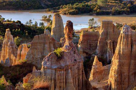 Earth Forest of Yuanmou in Yunnan Province, China - Exotic earth and sandstone formations glowing in...