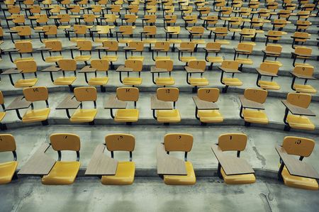 A large amount of empty seats with tables in a lecture hallの写真素材