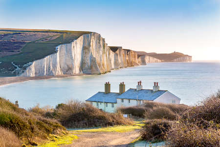 The Coast Guard Cottages and Seven Sisters Chalk Cliffs just outside Eastbourne, Sussex, England, UK.の写真素材