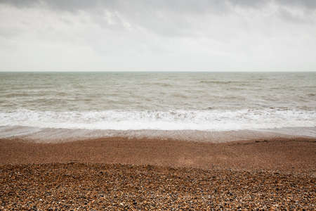 Atmospheric and Moody Long Exposure Photograph of Stoney Pebbled Beach and Sea at Brighton, East Sussex, England, UK.の写真素材