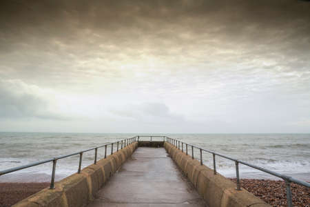 Atmospheric and Moody Long Exposure Photograph of Stone Pier at Brighton, East Sussex, England, UK with copy space.の写真素材