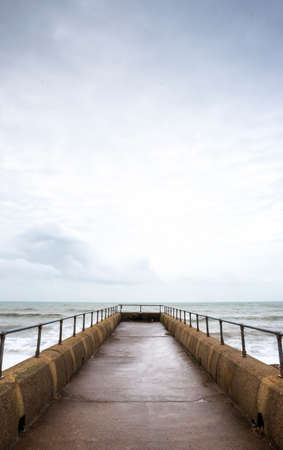 Atmospheric and Moody Long Exposure Portrait Photograph of Stone Pier at Brighton, East Sussex, England, UK with copy space.の写真素材