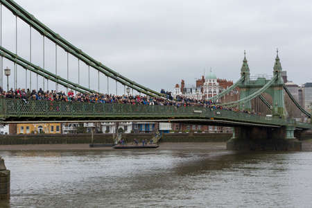LONDON, 10 MARCH 2018: Spectators on Hammersmith Bridge waiting to watch the Womens Head of the River Race WEHORR 2018 on the River Thames, London, England UKのeditorial素材