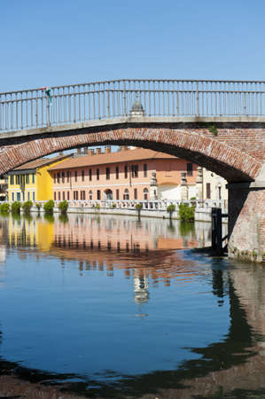 Gaggiano (Milan, Lombardy, Italy), bridge over the Naviglio Grande and colorful housesの写真素材