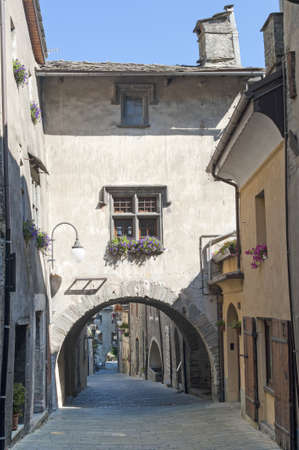Bard  Aosta, Italy  - Street of the medieval village with arch and flowered windowの写真素材