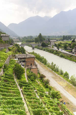 Roman bridge over the Adda river and panorama near Morbegno  Sondrio, Valtellina, Lombardy, Italyのeditorial素材
