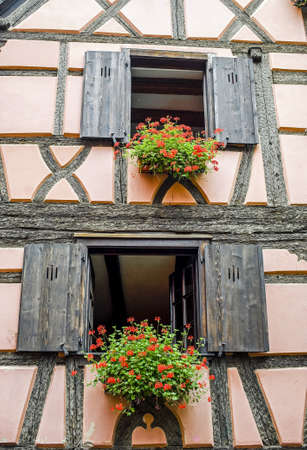 Bergheim (Bas-Rhin, Alsace, France) - Exterior of old half-timbered house with flowersの写真素材