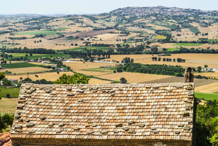 Marches (Ancona, Italy) - Landscape beyond a tiled roof at summer
