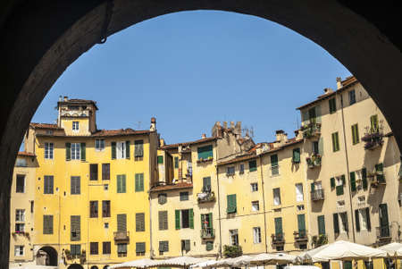 Lucca (Tuscany, Italy) Piazza Anfiteatro, historic square, old houses and blue skyの写真素材