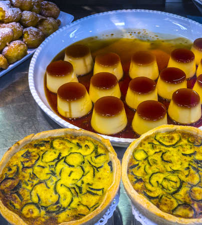 Zucchini's cakes and vanilla custards in the shop window of Milan (Lombardy, Italy)の写真素材