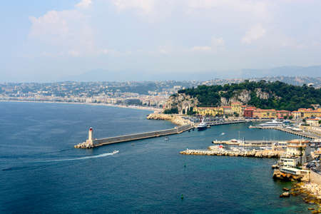 Nice (Alpes-Maritimes, Provence-Alpes-Cote d'Azur, France), panoramic view over the harbor, lighthouseの写真素材
