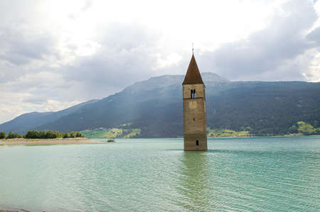 Resia (Bolzano, Trentino Alto-Adige, Italy): the famous tower in the lake at summerの写真素材