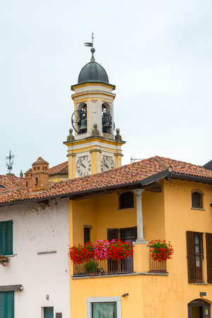 Historic buildings in Gaggiano (Milan, Lombardy, Italy), along the Naviglio Grande. Terrace with flowersの写真素材