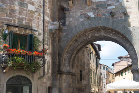 Lucca (Tuscany, Italy), balcony with potted flowers and archの写真素材