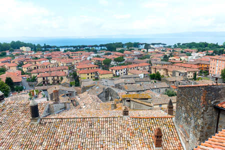 Bolsena (Viterbo, Lazio, Italy): typical tiled roofs of the old houses and the lakeの写真素材