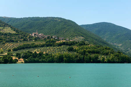 Lake and historic village of Pievefavera (Macerata, Marches, Italy) at summerの写真素材