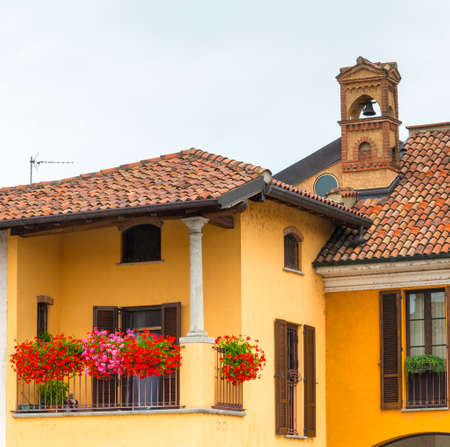 Historic buildings in Gaggiano (Milan, Lombardy, Italy), along the Naviglio Grande. Terrace with flowersのeditorial素材