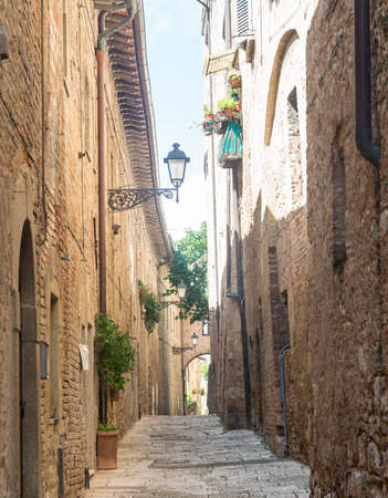 Colle di Val d'Elsa (Siena, Tuscany, Italy), historic city. Old houses with potted plants and flowersの写真素材