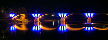 Pavia (Lombardy, Italy) by night: illuminated bridge over the Ticino riverの写真素材
