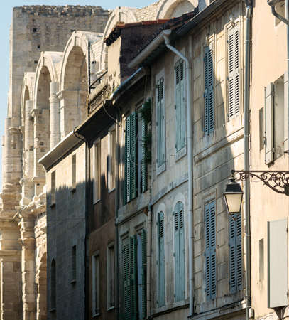 Arles (Bouches-du-Rhone, Provence-Alpes-Cote-d'Azur): typical old street and Les Arenes, Roman theatreの写真素材