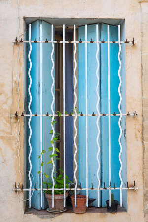 Arles (Bouches-du-Rhone, Provence-Alpes-Cote-d'Azur): typical old house, window with potted plantの写真素材