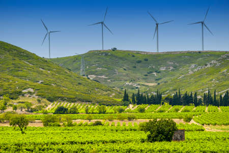Wind turbines and bales in Languedoc-Roussillon near Carcassonne (Aude, Languedoc-Roussillon, France) at summerの写真素材