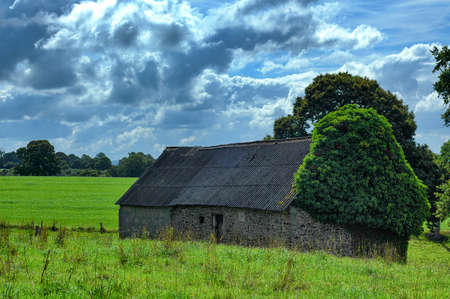 Old typical stone house in the countryside of Normandy (France) at summerの写真素材