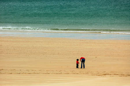 Sables-d'Or-les-Pins (Brittany, France).: the beach at summer, mother and sonの写真素材