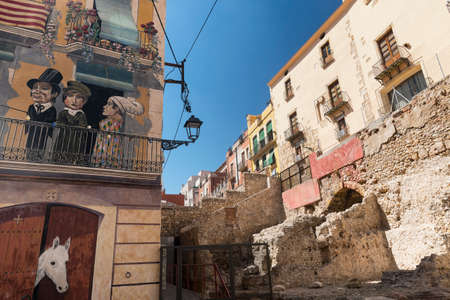 Tarragona (Catalunya, Spain): old street with historic buildings: painted houses and ruins of wallsの写真素材