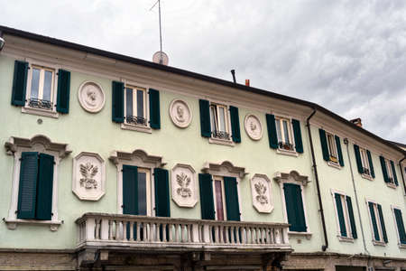 Saronno (Varese, Lombardy, Italy): green facade of historic palace, with windows and balconyのeditorial素材