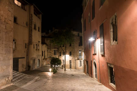 Girona (Gerona, Catalunya, Spain): old typical street by nightの写真素材