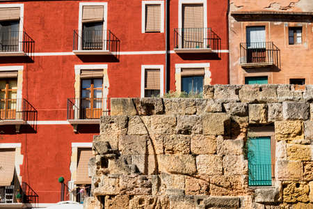 Tarragona (Catalunya, Spain): old street in the gothic quarter, near the medieval cathedral, with colorful houses and ruins of wallsのeditorial素材