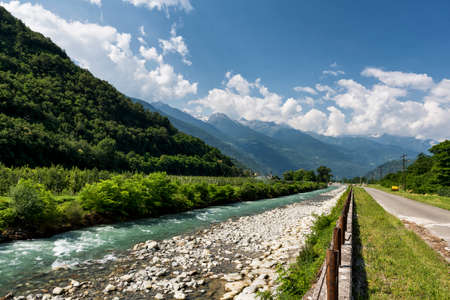 Sentiero della Valtellina, bicycle path along the Adda river iat summer. Vineyards near Tiranoの写真素材