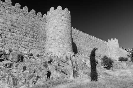 Avila (Castilla y Leon, Spain): the famous medieval walls surrounding the city. Black and white