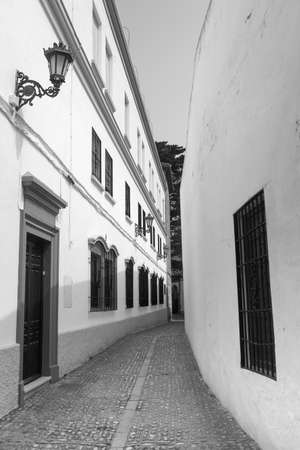 Ronda (Andalucia, Spain): old typical street with white houses. Black and whiteの写真素材