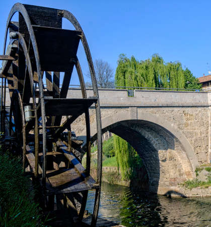 Groppello (Milan, Lombardy, Italy): the big wooden wheel on the Martesana canal known as Rudun and the old bridgeのeditorial素材