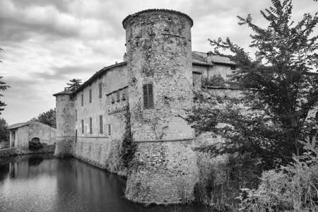 Lisignano (Piacenza, Emilia Romagna, Italy): the historic castle near Agazzano with waterlilies in the moat water. Black and whiteのeditorial素材