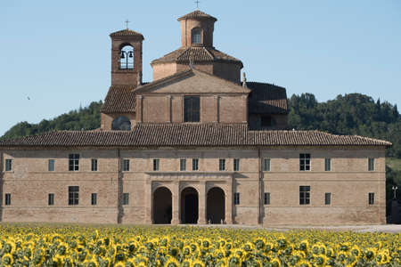 Urbania (Montefeltro, Pesaro Urbino, Marches, Italy). Historic farm and field of sunflowersのeditorial素材
