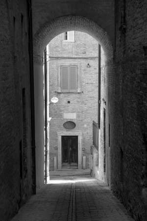Urbino (Marches, Italy): historic buildings at morning: alley. Black and white
