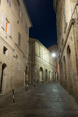 Fermo (Marches, Italy): historic buildings along an old typical street at evening.のeditorial素材