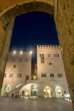 Historic buildings of Todi, Perugia, Umbria, Italy, in the main square of the city, known as Piazza del Popolo, by nightの写真素材