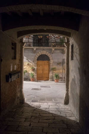 Asciano, Siena, Tuscany, Italy: the old city by night. A courtyardの写真素材