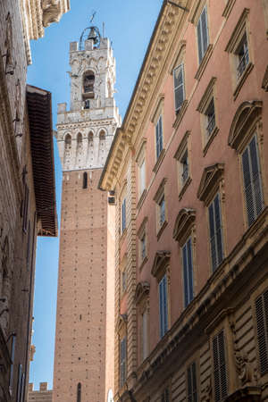 Historic buildings in SIena, Tuscany, Italy, at evening. Typical street and towerのeditorial素材