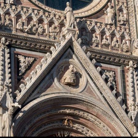 Historic buildings in SIena, Tuscany, Italy, at evening: exterior of the medieval cathedral (Duomo)の写真素材